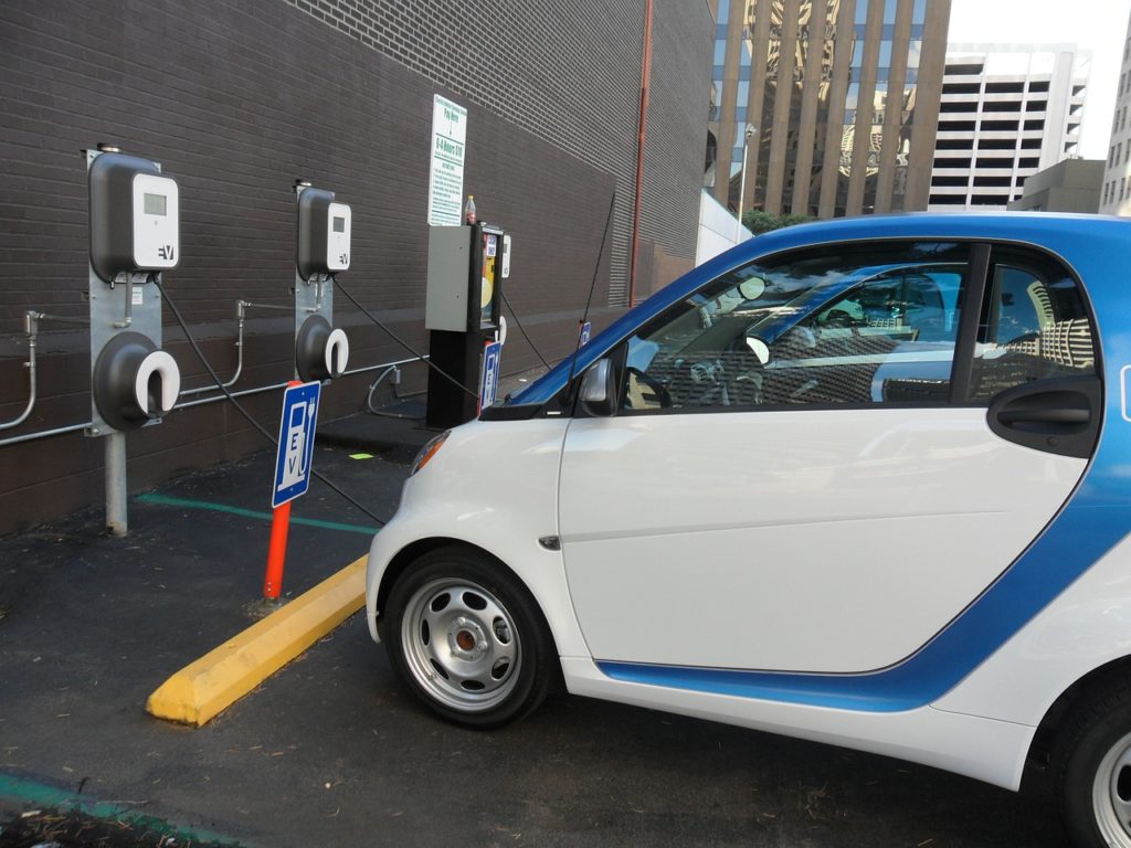 Electric cars charging in front of building