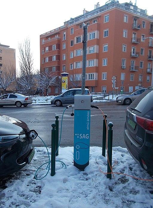 electric car charging in front of an apartment building